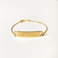 Closeup of our gold quote bracelet, engraved with the words: You will see it when you believe it. Quote Bracelet, Bracelet Quotes, Personal Narrative, When You Believe, Jewelry Quotes, Gold Engraving, Engraved Bracelet, Gold Dipped, Gold Plated Silver