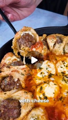 a skillet filled with meatballs and cheese