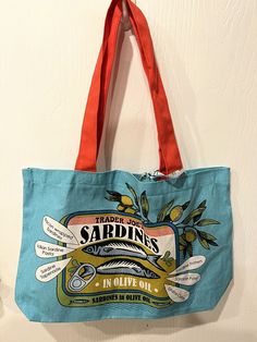 Get hooked with this Trader Joe's reusable shopping bag featuring a fun sardine pattern in blue/turquoise color. Made of heavy-duty cotton, this tote bag measures 14 inches in length and height, and 18 inches in width. It comes with straps for easy carrying and is foldable for convenient storage. This Trader Joe's bag is perfect for your grocery runs and other shopping needs. With its unique design and features such as the foldable feature, this bag is not only functional but also stylish. Grab this new with tags tote bag now and make a statement while helping the environment. Sardine Bag, Helping The Environment, Help The Environment, Feed Sacks, Trader Joe's, Reusable Shopping Bags, Trader Joes, Turquoise Color, Cotton Bag