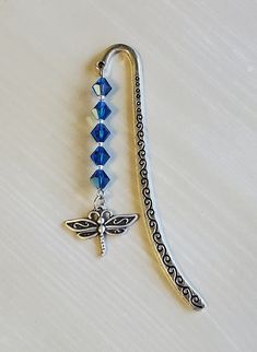 a silver and blue beaded lanyard with a dragonfly charm hanging from it