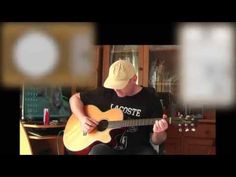 a man sitting in a chair playing an acoustic guitar