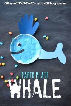 paper plate whale craft for kids on a blackboard with colorful sprinkles