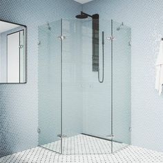 a bathroom with a walk in shower next to a sink and mirror on the wall