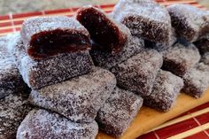 powdered sugar pastries stacked on top of each other with jam in the middle