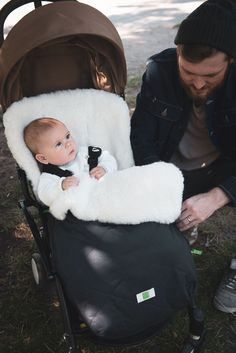 a man holding a baby in a stroller