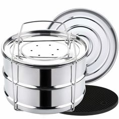 a set of four stainless steel pots and pans with a credit card on top