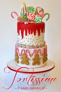 a three layer cake decorated with candy canes and candies