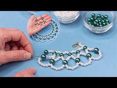 two hands are working on some beads