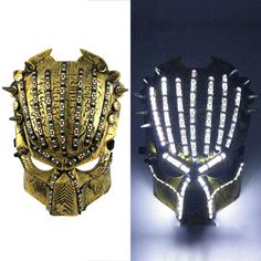 an image of a mask made out of gold and black metal with lights on it