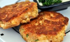 two crab cakes sitting on top of a white plate