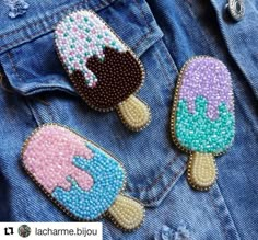 two ice creams are in the back pocket of a jean jacket, one is decorated with sequins