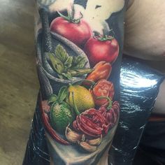 a person with a tattoo on their arm holding a plate of food and an animal