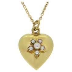 Here we have a beautiful pearl set pendant necklace. This antique pendant has been crafted from 18ct yellow gold into the the shape of a little love heart and expertly set with an array of round natural pearls in a floral formation. This motif sits atop plain polished backdrop before collectively being suspended from a modern matching 18ct yellow gold slim belcher chain. Condition: Used (Very Good) Weight: 4.9 grams Heart Dimensions: 15.5mm x 14mm x 7mm (excluding bail) Bail Dimensions: 3mm Pear Bolt Ring, Belcher Chain, Pearl Heart, Antique Pendant, Pearl Set, Heart Pendant Necklace, Natural Pearls, Chain Lengths, Heart Pendant