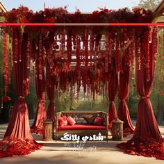 a red couch sitting under a canopy covered in flowers