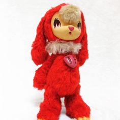 a red stuffed animal with a heart on it's chest