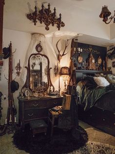 an old fashioned bedroom with antique furniture and clocks on the wall, along with antlers