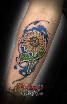 a sunflower tattoo on the arm