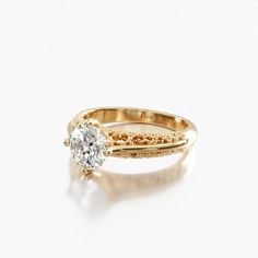 a yellow gold ring with a single diamond