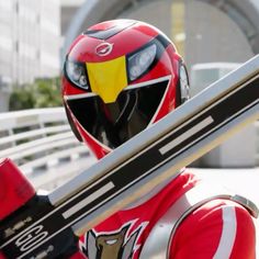 a man with a red and yellow helmet holding a pair of skis