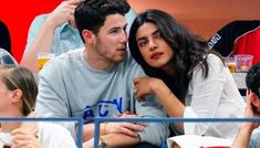 a man and woman sitting next to each other at a game