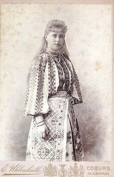 an old photo of a woman in traditional clothing