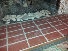 a fire place with rocks on the floor