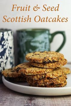 three oatmeal cookies stacked on top of each other in front of a mug