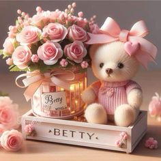 a teddy bear sitting on top of a wooden box with pink roses in the background