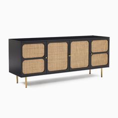 the sideboard is made out of black wood and wicker