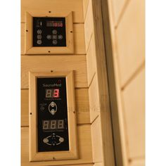 the control panel is mounted to the side of a wooden wall with buttons and numbers on it