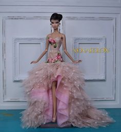 a barbie doll wearing a pink dress with flowers on it