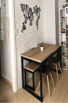 a dining room table with two chairs and a wall map on the wall behind it