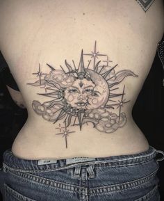 a woman's back with a sun and moon tattoo on her lower back side