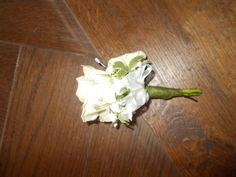 a bouquet of white flowers sitting on top of a wooden floor