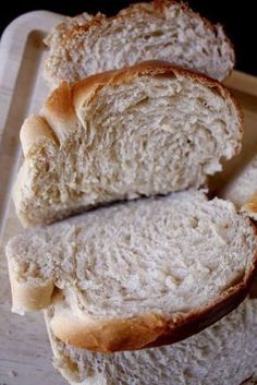 two loaves of bread sitting on top of a cutting board