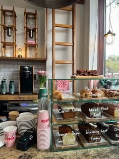 there are many cakes and pastries on display in the kitchen counter top area, along with other desserts