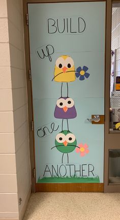 a door with an image of owls painted on it that says build up, one another