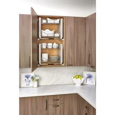 a kitchen with wooden cabinets and white counter tops