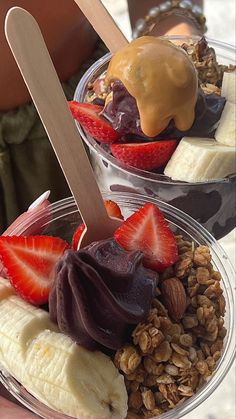 two plastic bowls filled with fruit and granola