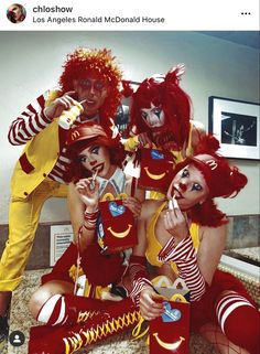 three people dressed in costumes posing for a photo