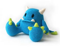 a crocheted blue stuffed animal with horns