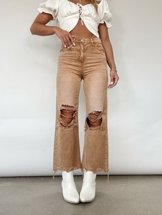 You'll be a trendsetter in Lane 201's Brown Crop Flare Denim! This piece features distressing at them hem and knees, a flare leg fit, pocket details, and a button and zipper closure. Pair with a cute white top and your favorite booties for the perfect transitional look! High Rise Distressing On Knees And Hem Flare Fit 100% Cotton Hand Wash Cold Distressed Flare Bottoms For Fall, Flare Distressed Bottoms For Fall, Distressed Flare Cotton Jeans, Ripped Cutoff Flare Jeans For Fall, Distressed Denim Flare Jeans For Fall, Ripped Flare Bottoms For Fall, Distressed Cutoff Cropped Jeans For Fall, Trendy Fall Flare Jeans With Frayed Hem, Distressed Cropped Jeans For Fall