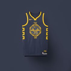 a basketball jersey hanging on a wall with the word, the bay written in gold