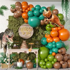 a dinosaur birthday party with balloons and decorations