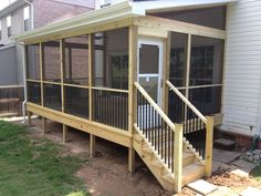 a house with a screened porch in the front yard and stairs leading up to it