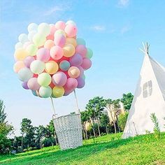 a teepee tent with balloons in front of it