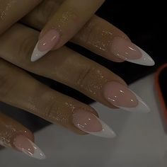 a woman's hands with white and pink nail polishes on their nails, in front of a mirror