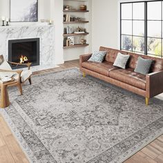 a living room filled with furniture and a fire place in the middle of the room