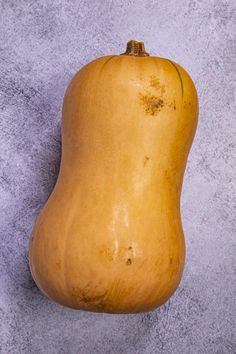 a yellow gourd sitting on top of a cement floor