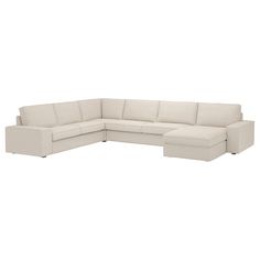 a white sectional couch sitting on top of a white floor